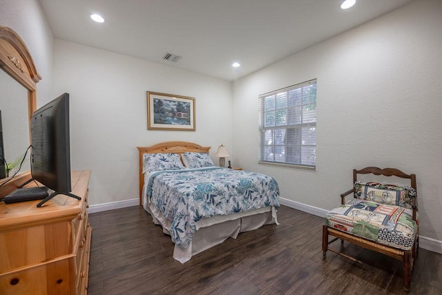 bedroom with dark hardwood / wood-style floors