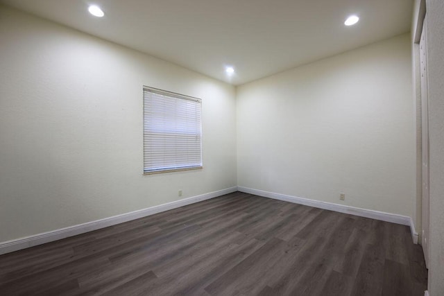 unfurnished room with dark hardwood / wood-style floors