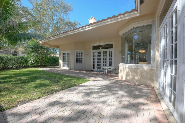 back of house featuring french doors, a yard, and a patio area