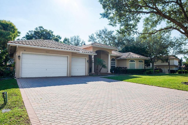 view of front facade with a front yard and a garage