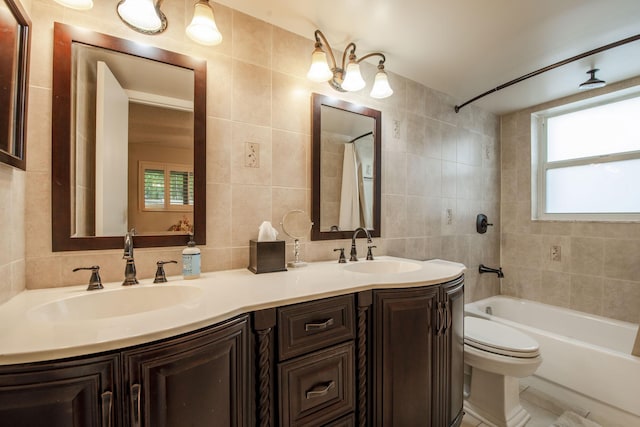 full bathroom with backsplash, vanity, shower / tub combination, tile walls, and toilet