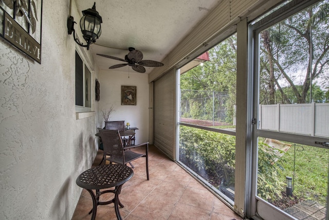 sunroom / solarium featuring ceiling fan