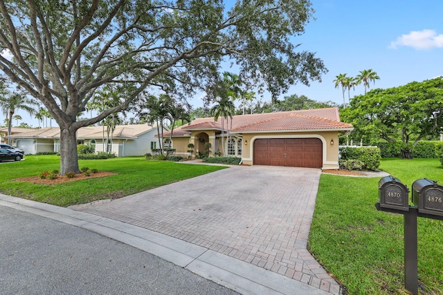 view of front facade featuring a front yard and a garage