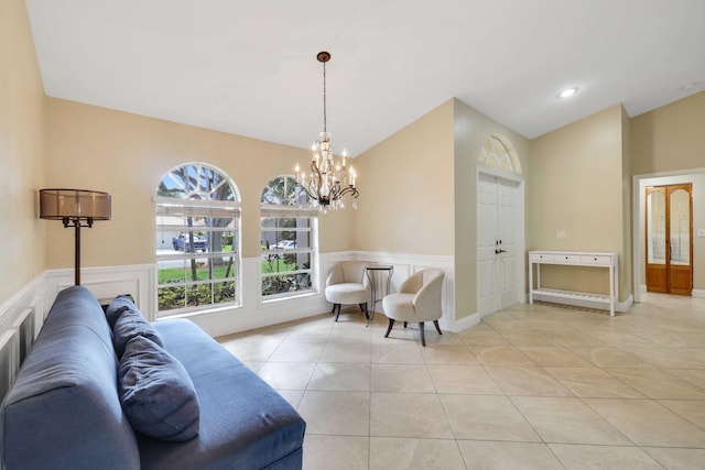 tiled living room with a notable chandelier