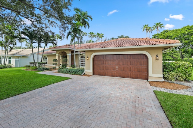 mediterranean / spanish-style house with a front yard and a garage