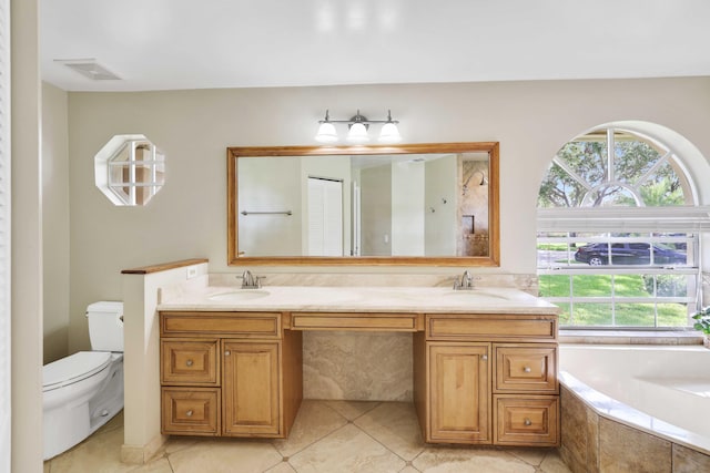 bathroom with a wealth of natural light, tile patterned flooring, vanity, and toilet