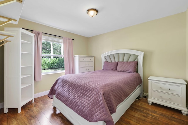 bedroom with dark hardwood / wood-style floors