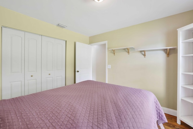 unfurnished bedroom featuring a closet and hardwood / wood-style flooring