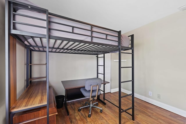 bedroom with hardwood / wood-style flooring