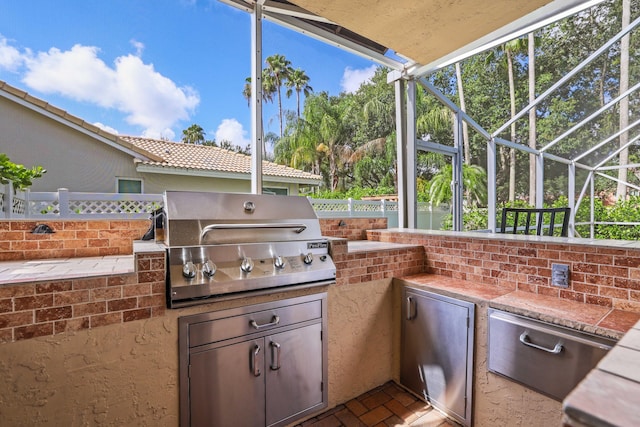 view of patio featuring an outdoor kitchen, a lanai, and a grill