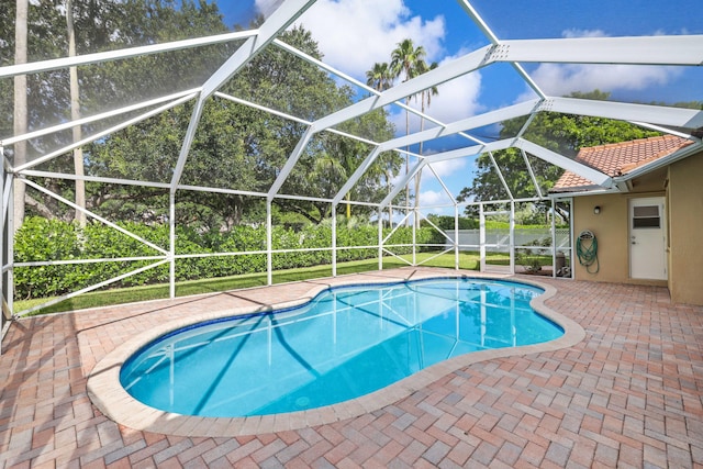 view of swimming pool with a lanai and a patio area