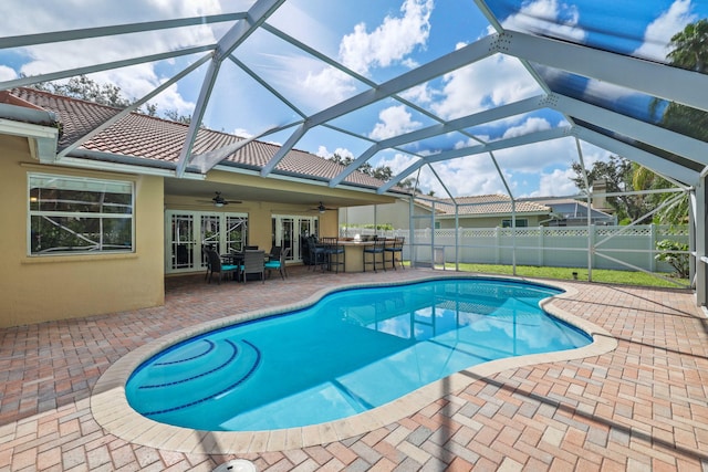 view of pool featuring ceiling fan, exterior bar, and a patio