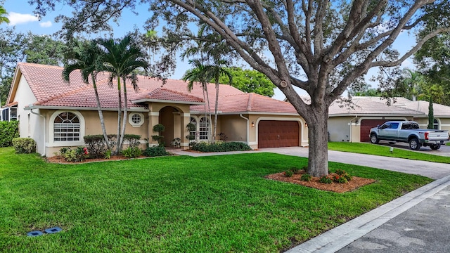 view of front of house with a garage and a front lawn