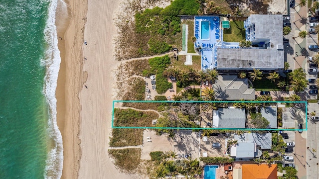 drone / aerial view with a water view and a view of the beach