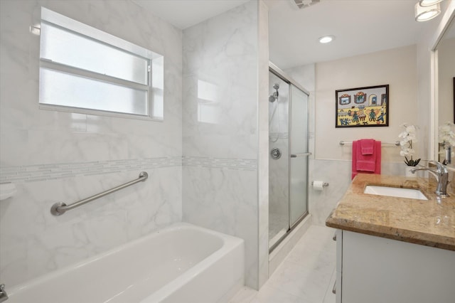 bathroom featuring vanity and separate shower and tub