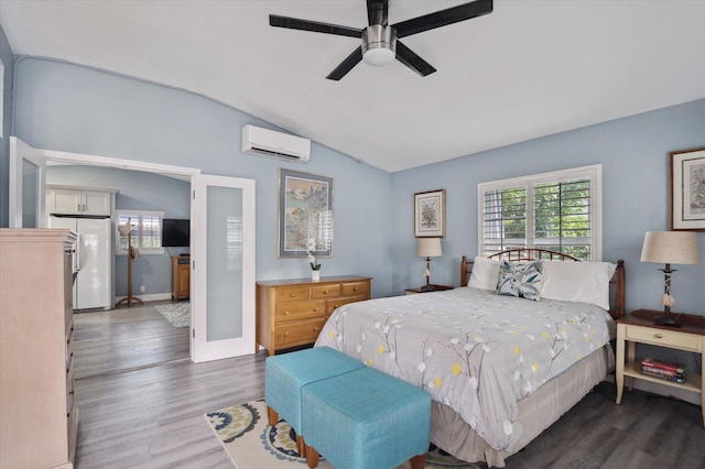 bedroom featuring a wall mounted AC, ceiling fan, dark hardwood / wood-style flooring, vaulted ceiling, and white refrigerator