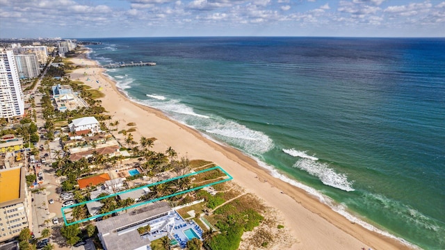 birds eye view of property featuring a water view and a view of the beach