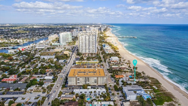 drone / aerial view featuring a water view and a beach view