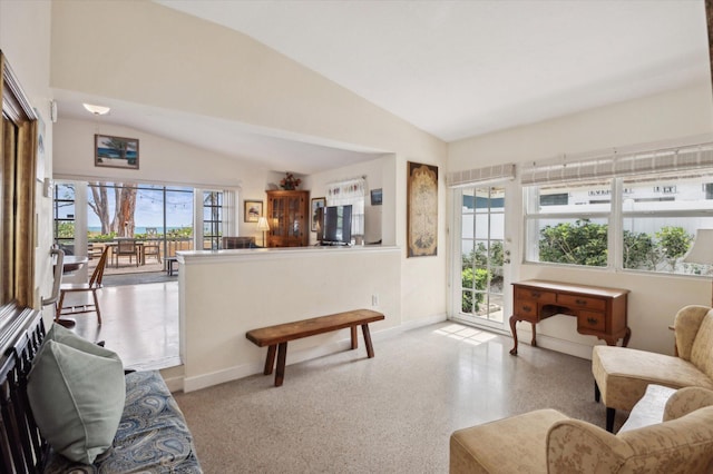 living room with vaulted ceiling and a wealth of natural light