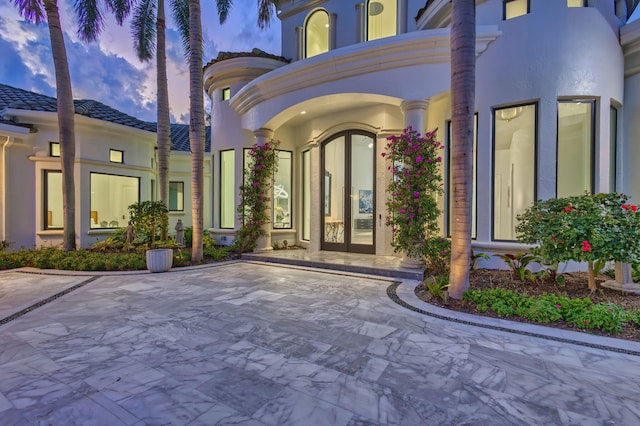 exterior entry at dusk with french doors