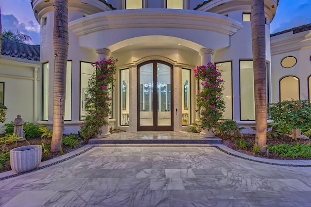 exterior entry at dusk with french doors