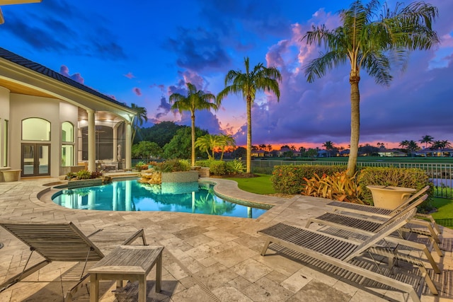 pool at dusk with a patio