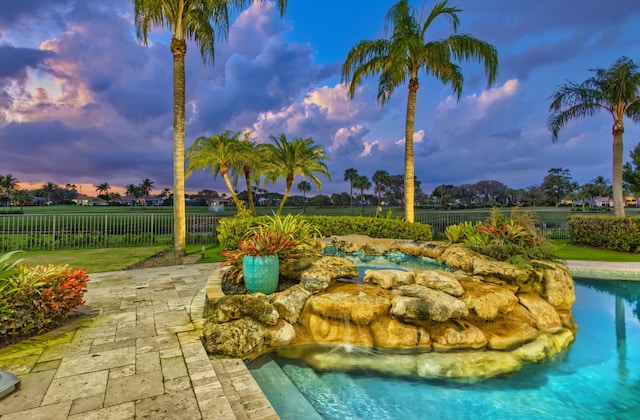 view of pool at dusk