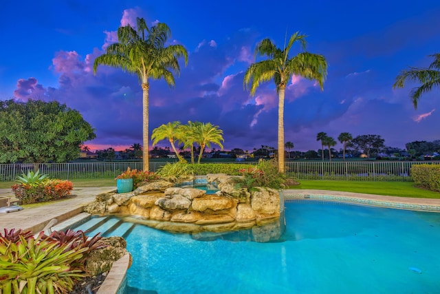 view of pool at dusk