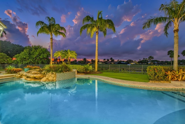 view of pool at dusk