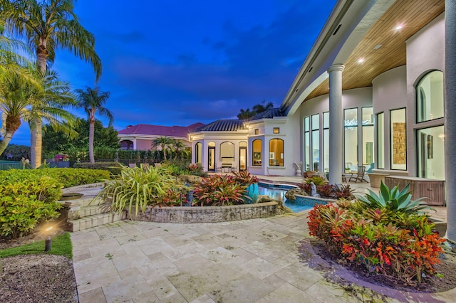 view of patio terrace at dusk