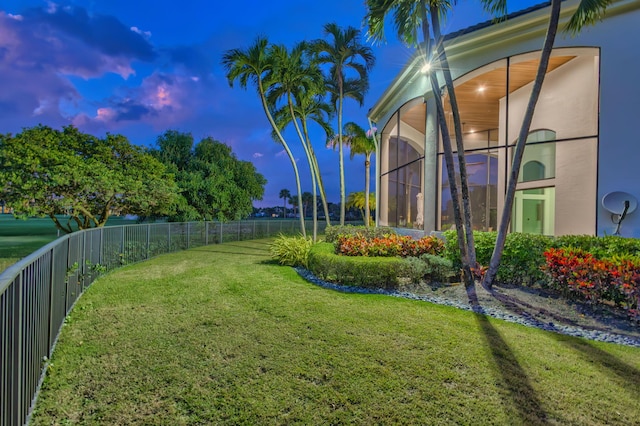 view of yard at dusk