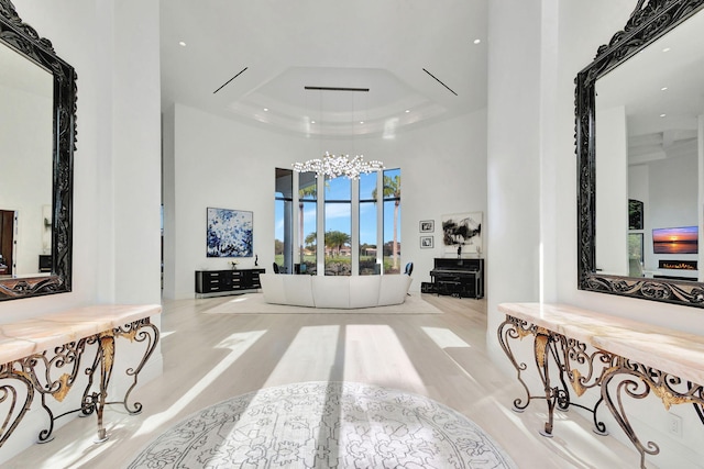 interior space with a tray ceiling and a high ceiling