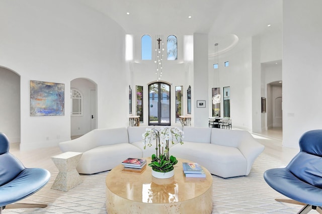 living room featuring a towering ceiling