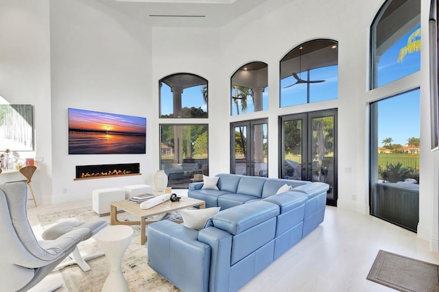 living room with a towering ceiling and french doors