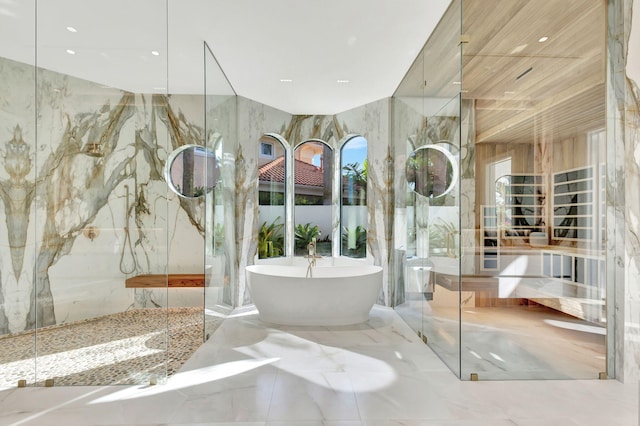 bathroom with tile walls and plus walk in shower