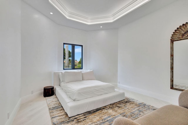 bedroom featuring a tray ceiling and ornamental molding