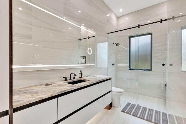 bathroom with an enclosed shower, vanity, toilet, and tile walls