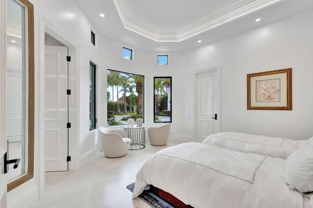 bedroom with a high ceiling, a raised ceiling, and ornamental molding