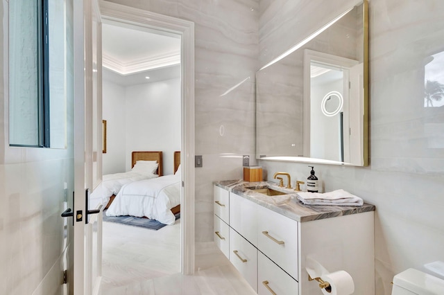 bathroom featuring vanity, toilet, and ornamental molding