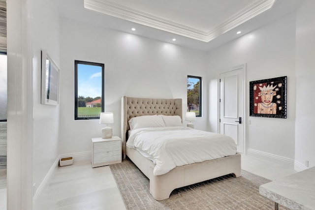 bedroom with crown molding and a tray ceiling