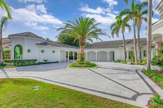 mediterranean / spanish-style home with a garage