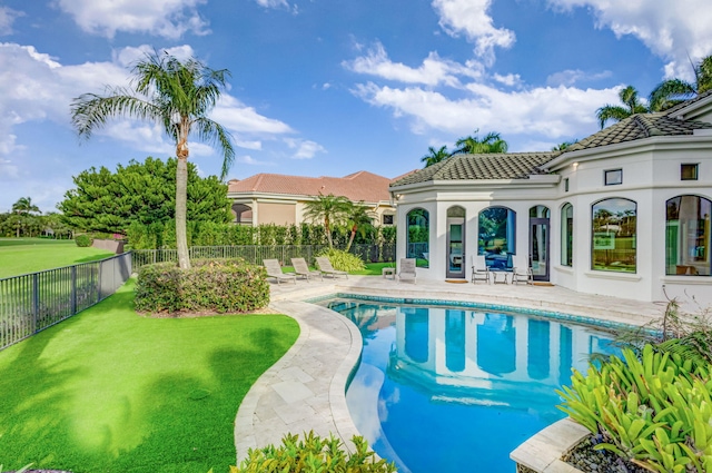 view of pool featuring a yard and a patio