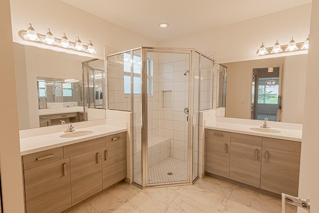 bathroom featuring vanity and a shower with door