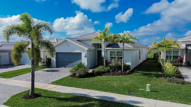 ranch-style house with a garage and a front lawn