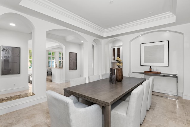 dining room featuring a tray ceiling and crown molding