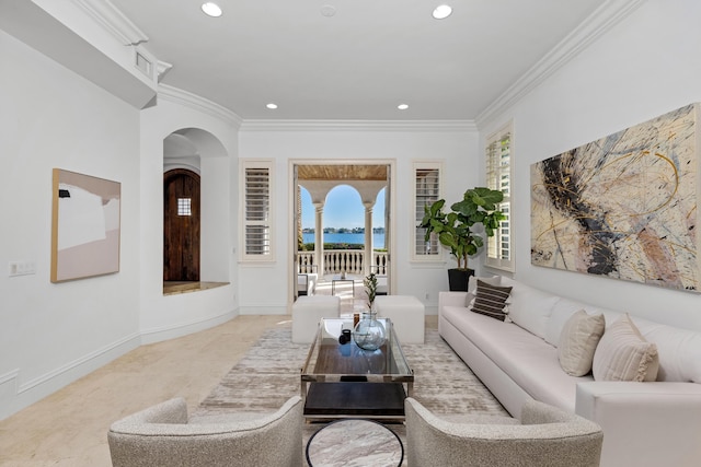 carpeted living room featuring a water view and ornamental molding