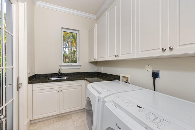 washroom with washer and clothes dryer, crown molding, cabinets, and sink