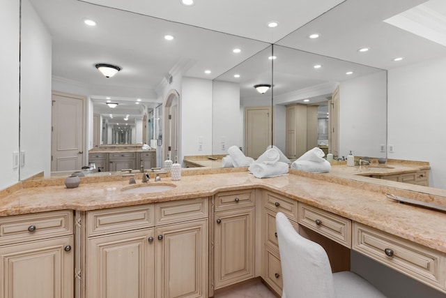 bathroom with crown molding and vanity