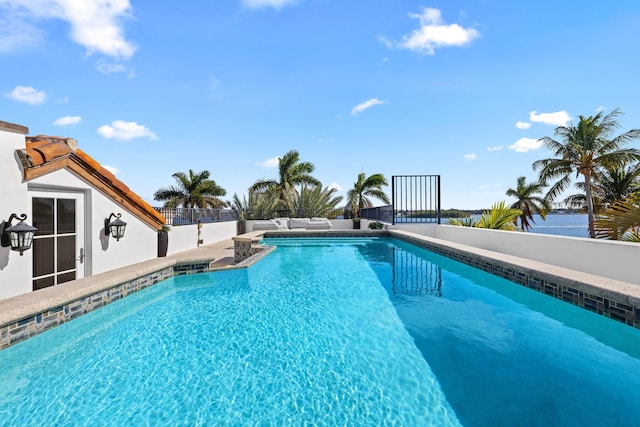 view of swimming pool with a water view