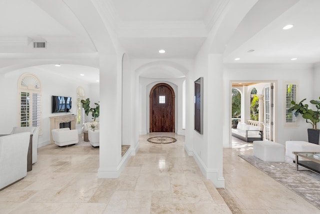 foyer entrance with french doors and ornamental molding